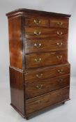 A George III mahogany chest on chest, with two short and three long drawers between reeded canted