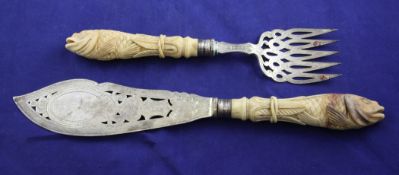 A pair of Victorian marine ivory handled silver fish servers, each handled carved as a fish