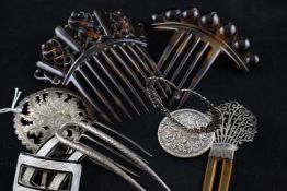 A group of assorted American hair combs, badges and buckles including a Tiffany silver comb, a