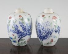 A pair of Chinese wucai small ovoid jars, Kangxi period, each painted with flowers and foliage,