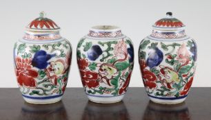 A set of three Chinese wucai vases and two covers, 17th century, each painted with two lion-dogs