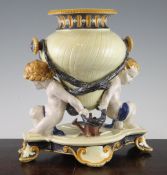 A Wedgwood majolica figural vase, mid 19th century, the neo-classical vase bound by wreath swags and