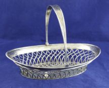 A George III silver oval cake basket, with pierced trellis body and engraved foliate and ribbon