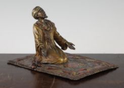 A 19th century Austrian cold painted bronze figure of an Arab at prayer, kneeling on a rectangular