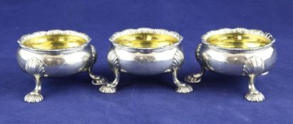 A set of three George II silver bun salts, engraved with the Jervoise? family crest, with shell