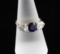An 18ct gold and platinum three stone sapphire and diamond ring, the central oval cut sapphire