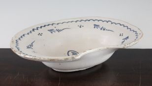 A French faience barber`s bowl, 18th century, painted in blue with flower sprays, 13in.