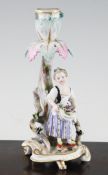 A German porcelain figural candlestick, late 19th century, modelled with a lady flower seller,