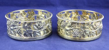 A good pair of George III silver gilt wine coasters, both inscribed, "Burton Hunt, 7th April, 1807",