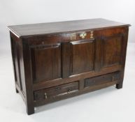 An 18th century oak mule chest, the front with three fielded panels over two base drawers and with