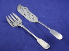 A pair of Victorian silver fiddle pattern fish servers, with engraved initial and blades decorated