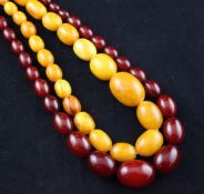 A single strand graduated yellow amber bead necklace and graduated red bakelite bead necklace,
