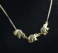 An Italian 18ct gold, sapphire and diamond set elephant necklace, with three conjoined gem set