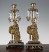 A pair of glass lustre and brass candle sconces, modelled as flowering trees with figures below,