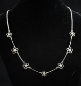 An 18ct white gold and diamond set necklace, with alternating bar and diamond set foliate links,