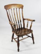 A 19th century beech and elm laid back armchair, with turned supports, united by stretchers
