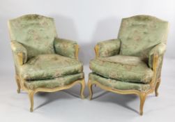 A pair of Louis XV design upholstered armchairs, with button back fabric, serpentine seats and