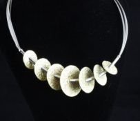 A modern Italian two colour 18ct gold Ronco necklace, modelled as seven graduated textured yellow