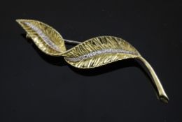 A 1970`s 18ct gold and diamond set leaf brooch, 3in.