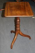 An early 19th century mahogany tripod table, with rectangular top and reeded downswept supports, W.