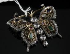 An 18ct gold and silver, ruby emerald, sapphire and diamond set butterfly brooch, 2.25in.