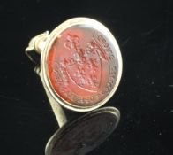 A Victorian 14ct gold and carnelian set calendar fob seal, the oval carnelian with carved matrix and
