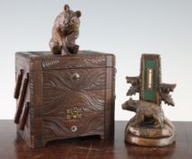 A late 19th / early 20th century Black Forest carved jewellery casket, with three folding trays