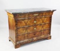 A Charles X French burr walnut commode, with black marble top over a cushion frieze drawer and three