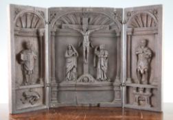 A 19th century European carved oak triptych, the centre carved with The Crucifixion, 22in.