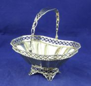 An Edwardian silver gilt bonbon basket, of rounded rectangular form, with panelled body and