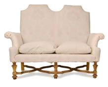 A BAROQUE STYLE SOFA, EARLY 20TH CENTURY, with white cotton fabric cover over 20th century damask, a