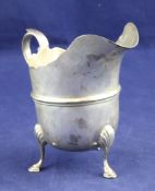 An Edwardian silver helmet shaped cream jug, with banded girdle, on tripod hoof feet, Henry Wigfull,