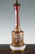 A Bohemian ruby and white overlaid glass lamp base, late 19th century, decorated with reserves of