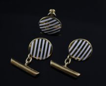 A pair of 18ct gold and striped white enamel cufflinks and a matching stud, of circular form,
