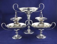 A George V silver three piece table garniture, comprising an epergne with two hanging receivers