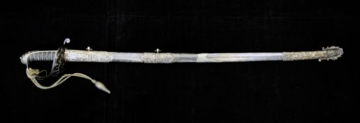 A 19th century silver mounted officer`s dress sword, the etched blade inscribed `Presented