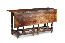 A WILLIAM AND MARY OAK SINGLE LEAF GATELEG DINING TABLE, CIRCA 1690, the cleated planked top on