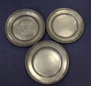 A pair of pewter broad rim chargers, two touch marks to the reverse and a GV mark to the front,