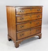 A George III oak and mahogany crossbanded chest, of four long graduated drawers with brass ring