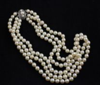 A triple strand cultured pearl necklace with cultured pearl set silver clasp, 15in.