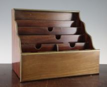 A 19th century mahogany waterfall shape stationery cabinet, with brass inset borders throughout,