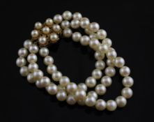 A triple strand cultured pearl bracelet with cultured pearl set flower head shaped gold clasp,