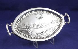 A George III silver mounted oval teapot stand with later handles and later embossed decoration,