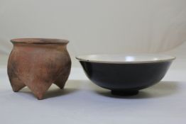 A Chinese Henan black glazed bowl, 8.5in. and a Chinese neolithic style pottery tripod vessel, 5.