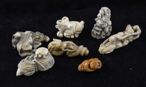 Six ivory netsuke and an ivory carving, two in the form of dragons, two carved as water buffalo, one