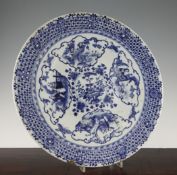 A Chinese blue and white dish, Qianlong seal mark, 19th century, painted to the centre with