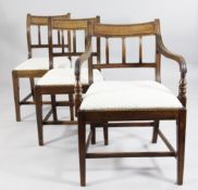 A set of eight early 19th century mahogany dining chairs, two with arms, six singles, with shaped