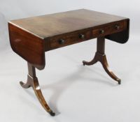 A Regency mahogany sofa table, with trestle end supports, downswept legs and brass capped castor