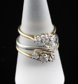 Two 18ct gold and three stone diamond rings and a 9ct white gold and solitaire diamond ring, sizes