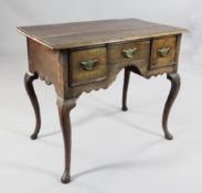An 18th century oak low boy, fitted three drawers with shaped frieze, on cabriole legs and pad feet,